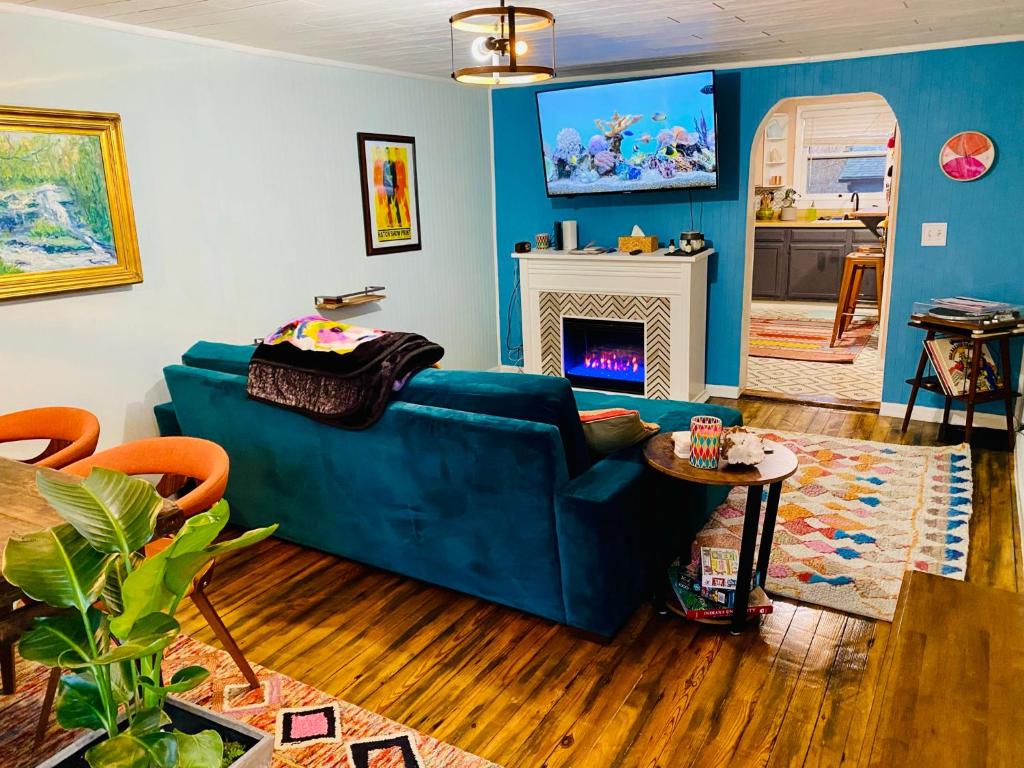 a living room with a blue couch and a fireplace at Boho-Chic Travel Pad - Unit 2 in Bloomington