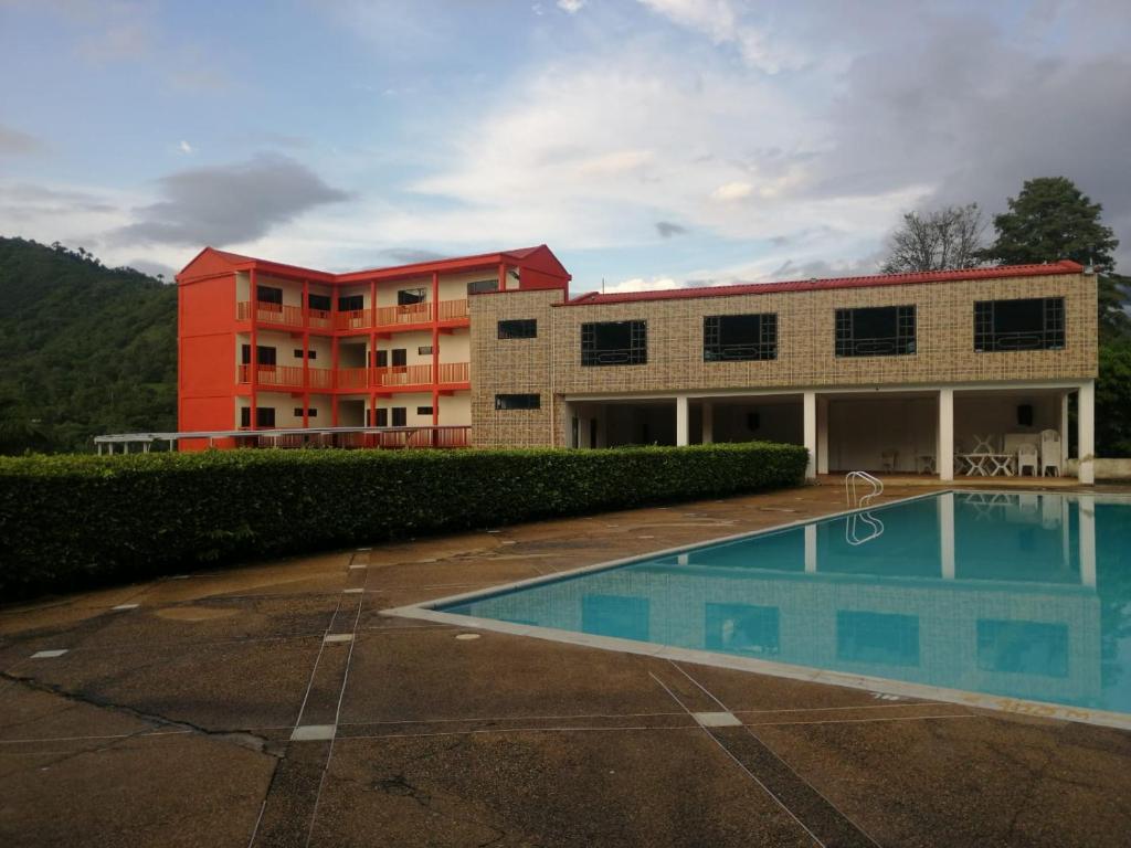a building with a swimming pool in front of a building at Finca Hotel - Piscina La Johanna in La Mesa