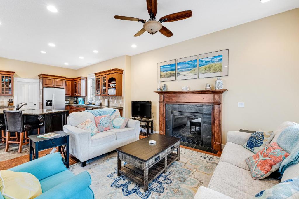 a living room with a couch and a fireplace at The Happy Place in Seaside