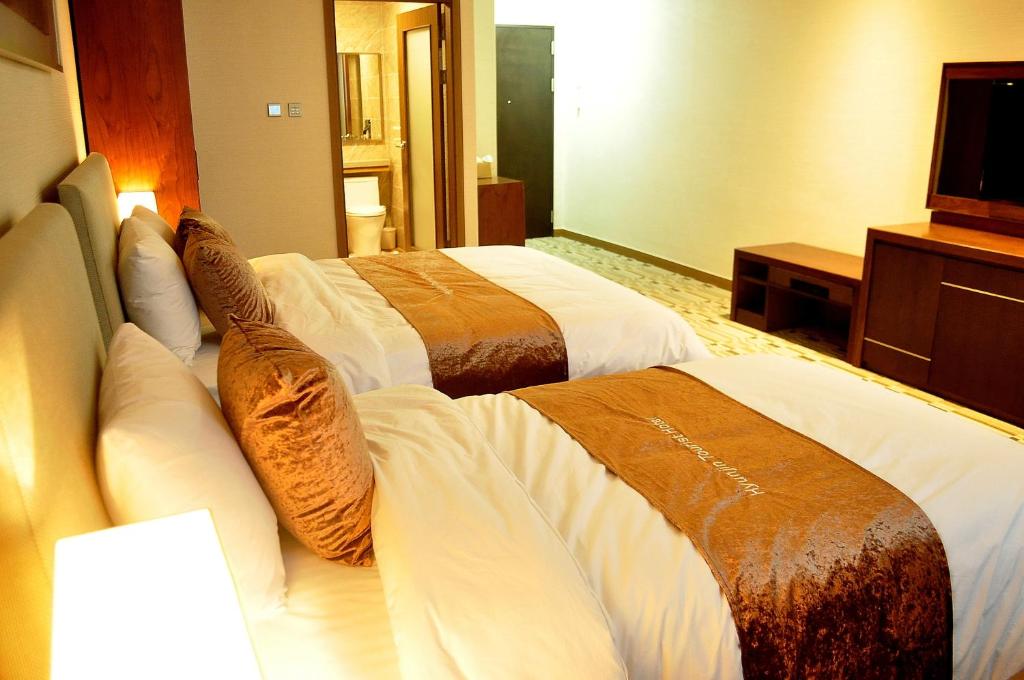 Postel nebo postele na pokoji v ubytování Hyunjin Tourist Hotel