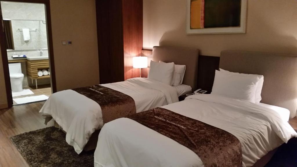 Postel nebo postele na pokoji v ubytování Hyunjin Tourist Hotel