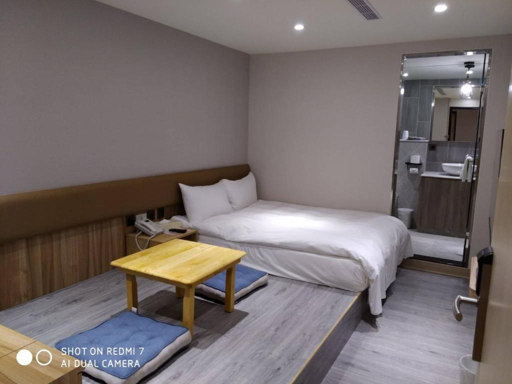 Postel nebo postele na pokoji v ubytování Michi Hotel - Luodong