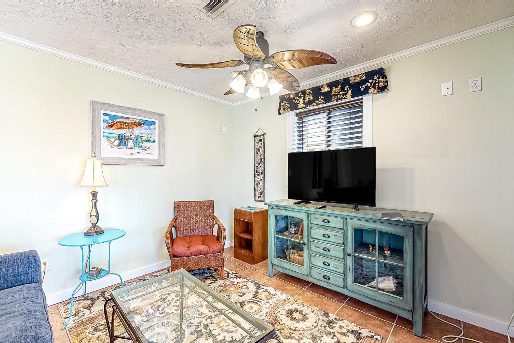 a living room with a flat screen tv and a couch at Pelican House in Saint Joe Beach