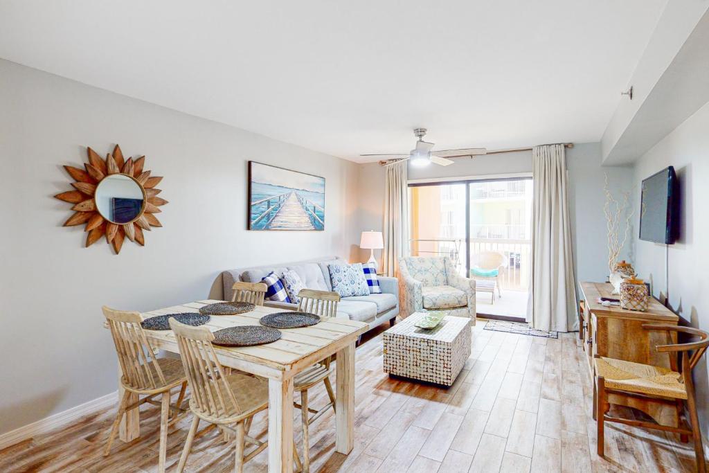 a living room with a table and a couch at Harbour Place 108 in Gulf Shores