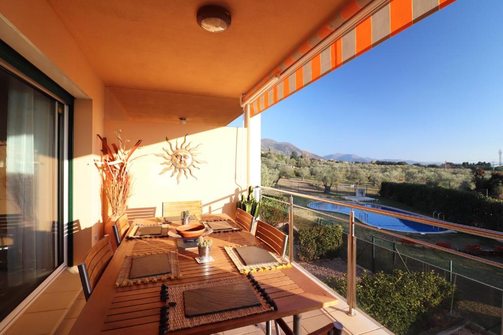 a balcony with a table and a view of a pool at Sun Village P2 - Immo Barneda in Palau-Saverdera