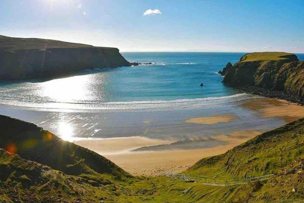 a view of a beach with the ocean at Silver Strand Chalets in Glencolumbkille