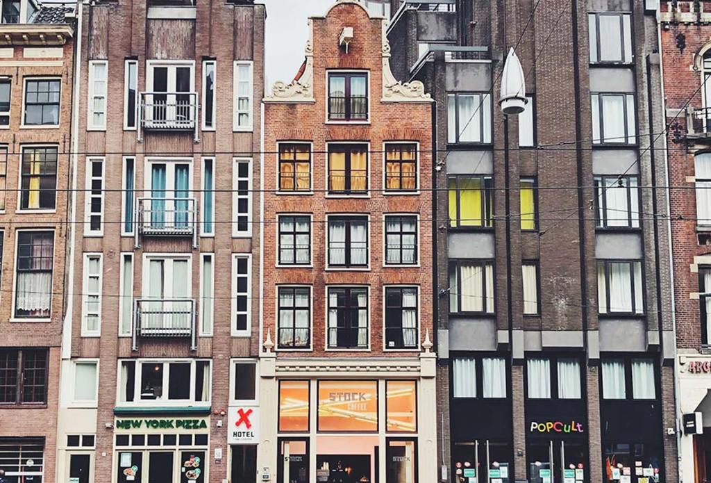 a group of tall buildings in a city at Hotel The Exchange in Amsterdam