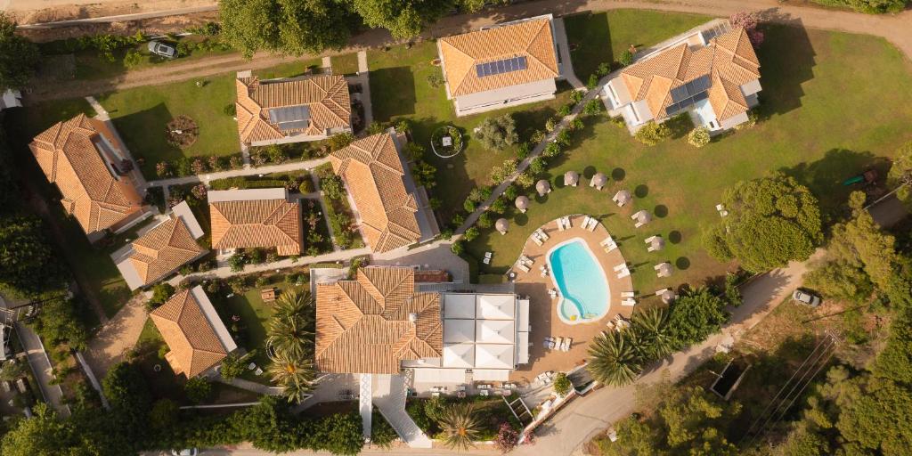 an overhead view of a house with a swimming pool at Mandraki Village Boutique Hotel in Koukounaries