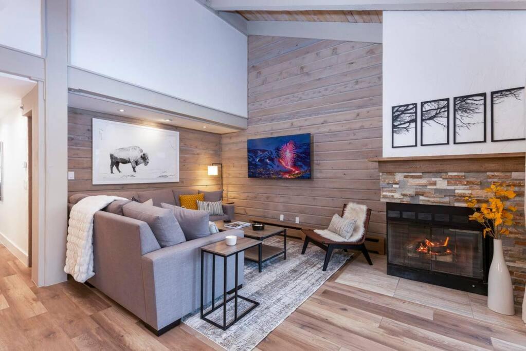 a living room with a couch and a fireplace at Updated 3 BR, 2 BA with Pool & Hot Tub - Stunning Mountain Views! in Snowmass Village