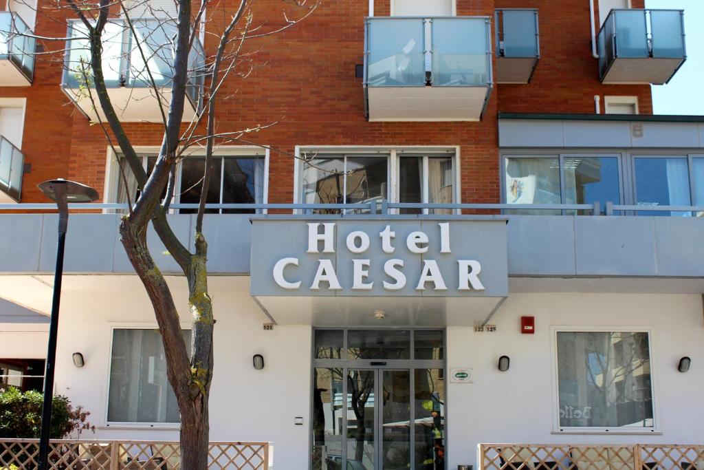 a hotel caserara sign on the side of a building at Hotel Caesar in Pesaro