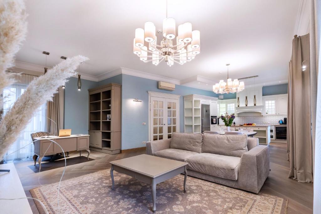 a living room with a couch and a table at Luxury 2BDR Heart Of Old Town in Vilnius