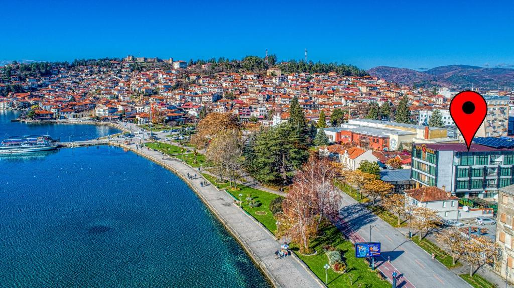 an aerial view of a city with a red marker at Hotel Nova Riviera in Ohrid