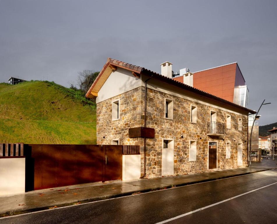 an old stone building on the side of a street at SOLOA LANDETXEA in Bakio