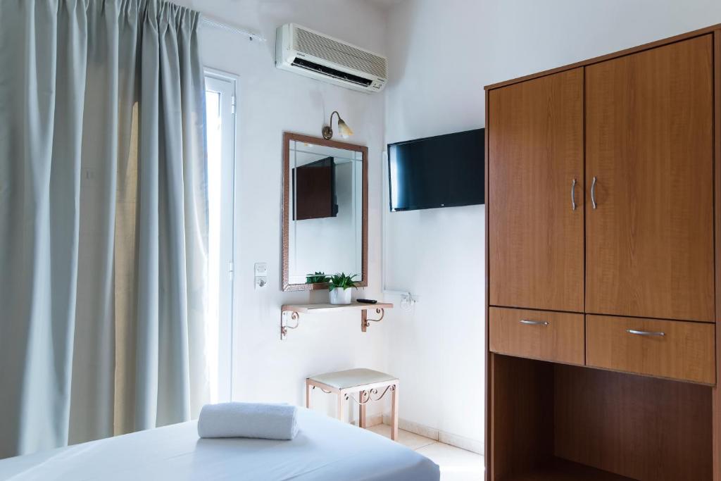 Łóżko lub łóżka w pokoju w obiekcie Ilios 1 Central