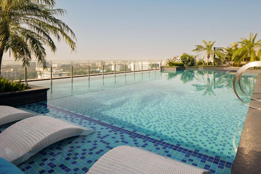 a swimming pool with a view of the ocean at Radisson Blu Mumbai International Airport in Mumbai