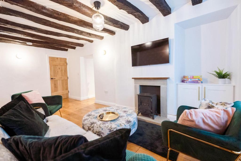 a living room with couches and a fireplace at Host & Stay - Iris Cottage in Pickering