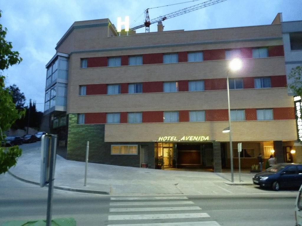 a building with a crane on top of it at Hotel Avenida El Morell in El Morell