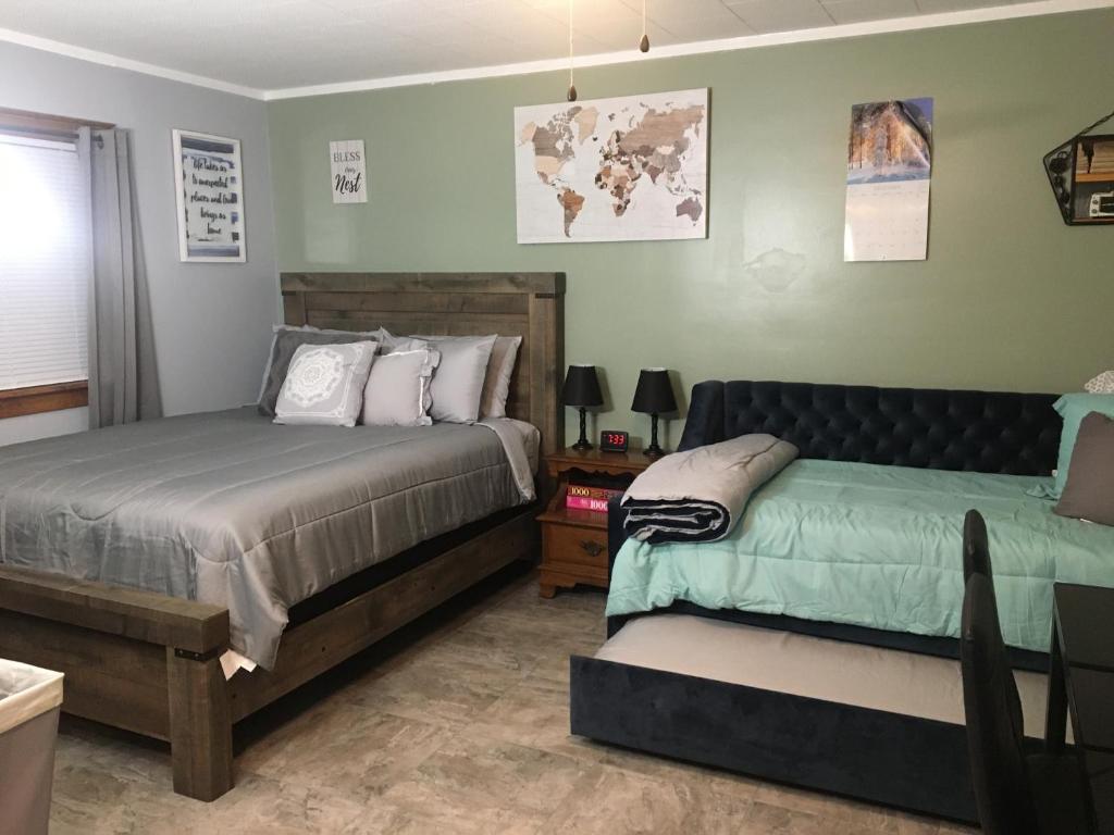 a bedroom with two beds and a couch at Home Away From Home, Recently Renovated in North Troy
