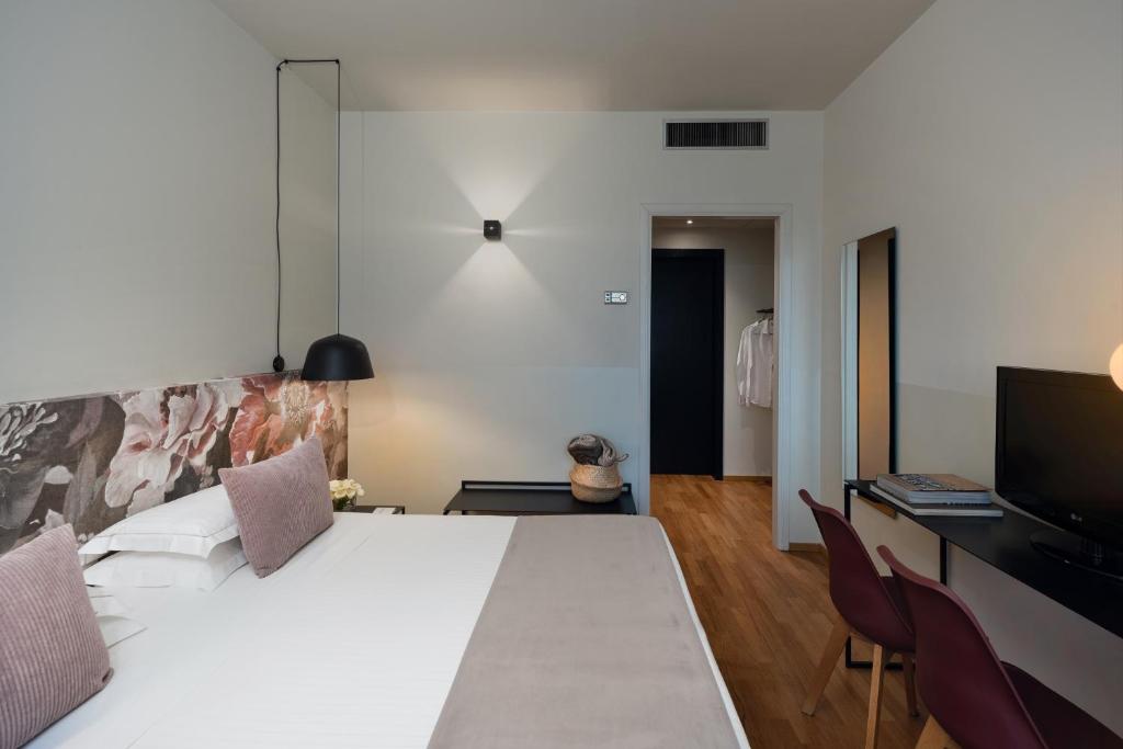 Postel nebo postele na pokoji v ubytování Hotel Leopardi