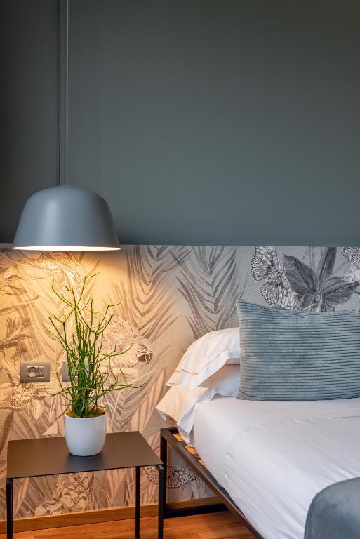 Postel nebo postele na pokoji v ubytování Hotel Leopardi