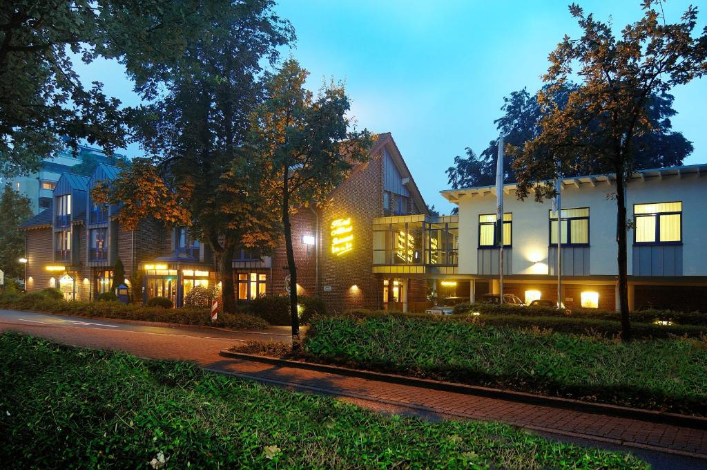 a row of buildings on a street at night at Akzent Hotel-Restaurant Albert in Dorsten