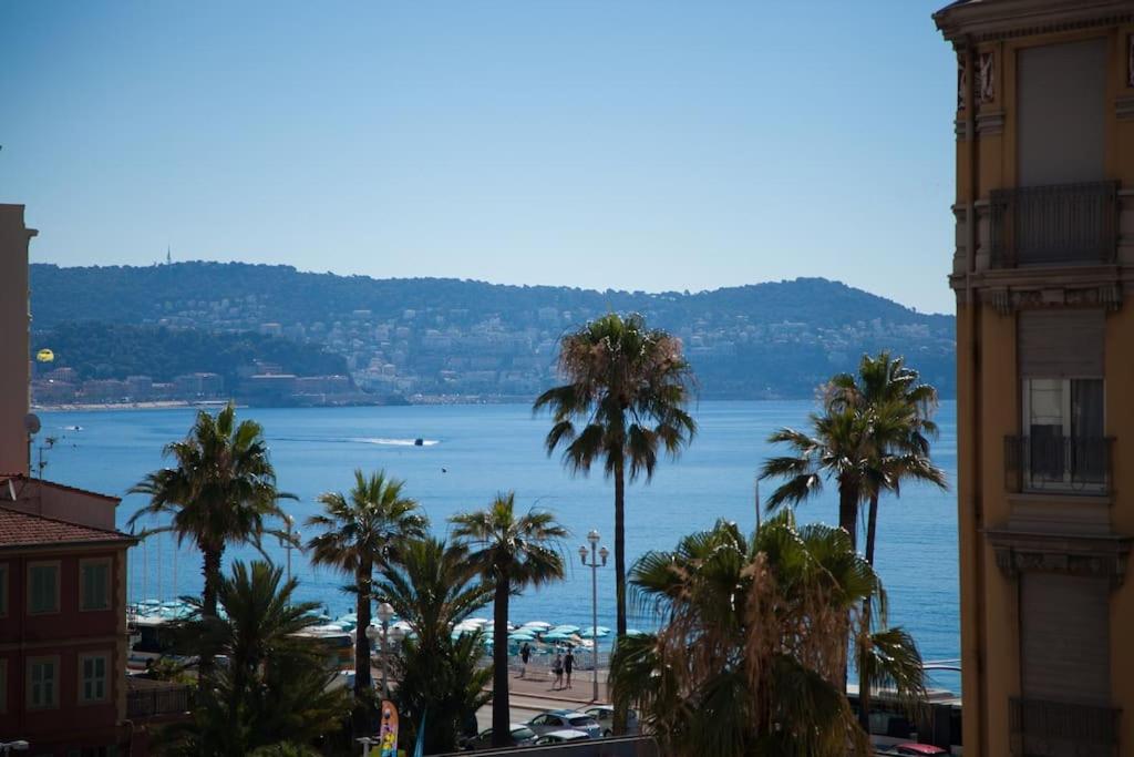 a view of a beach with palm trees and the ocean at Stylish Studio in only 50 meters from beach ! in Nice