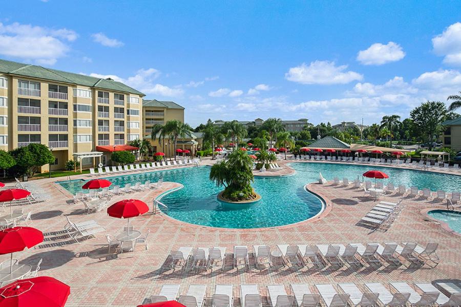 una gran piscina con sillas y sombrillas en Silver Lake Resort by Capital Vacations, en Orlando