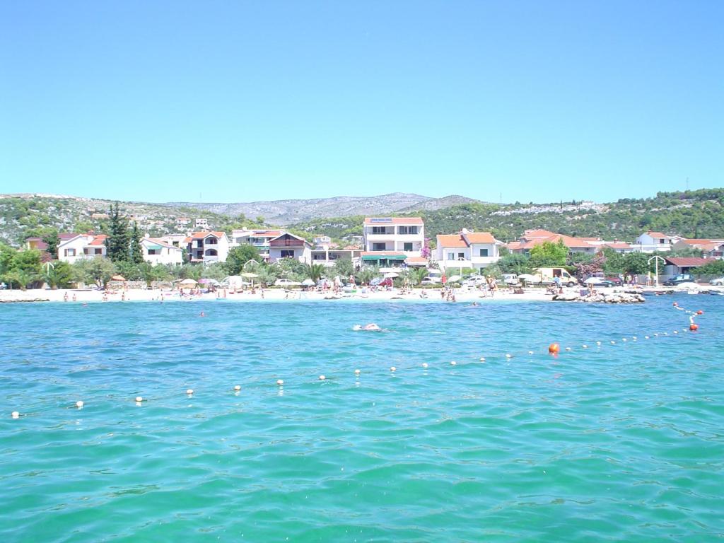 a group of people swimming in the water near a beach at Villa Radic in Poljica