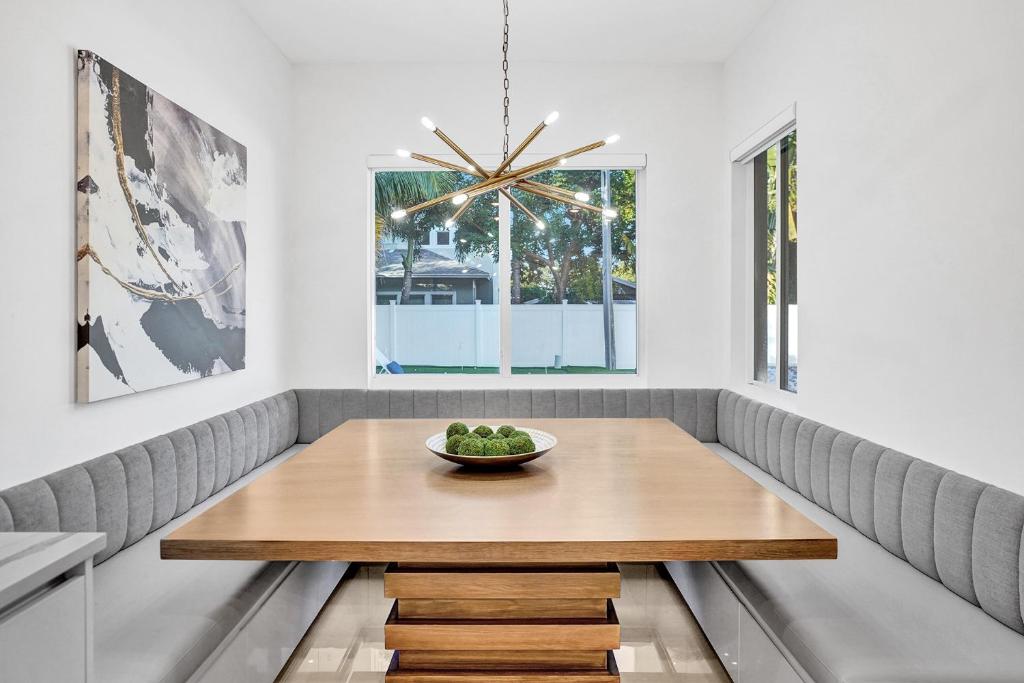 a dining room table with a bowl of fruit on it at Mimosa Sunrise Villa in Pompano Beach