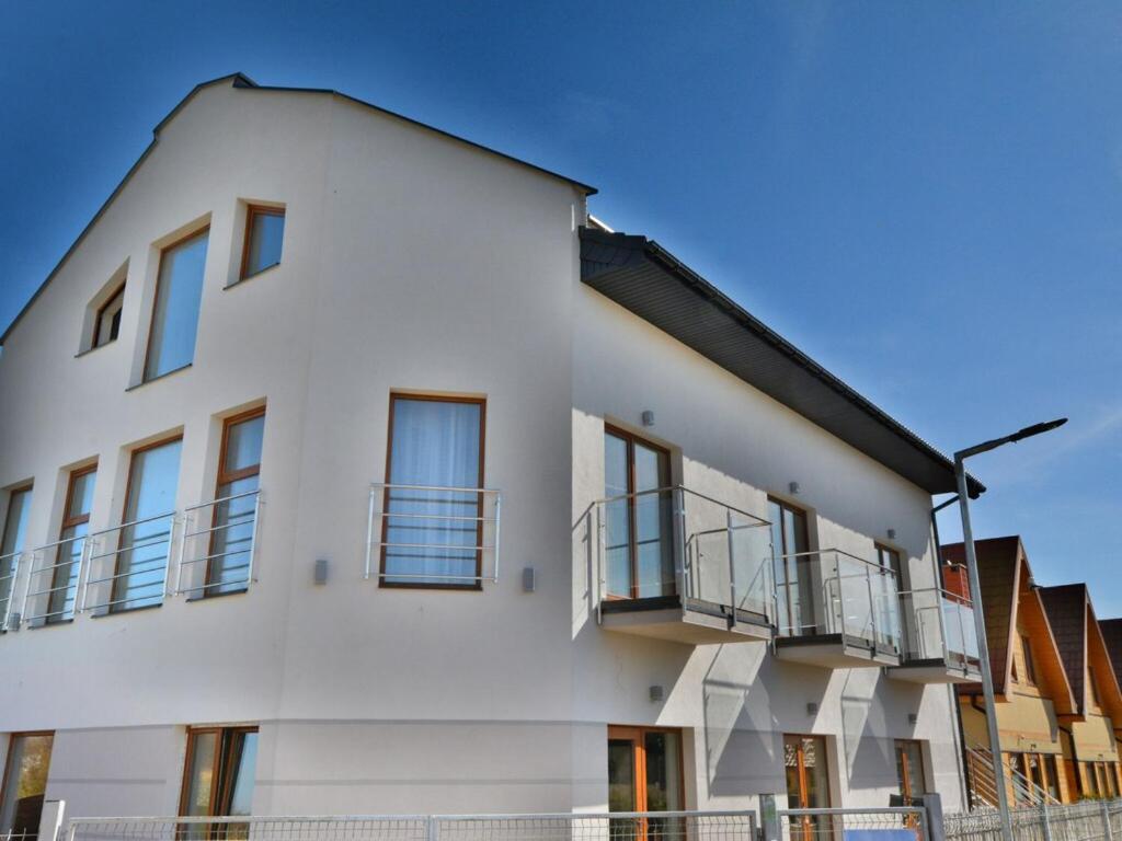 薩比諾沃的住宿－Holiday resort, Sarbinowo，带阳台的白色建筑