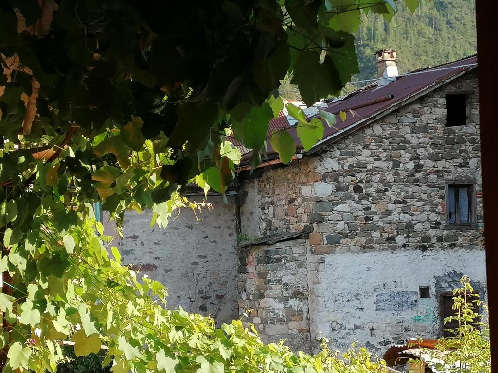 a stone building with a chimney on top of it at L'inizio... in Val di Zoldo