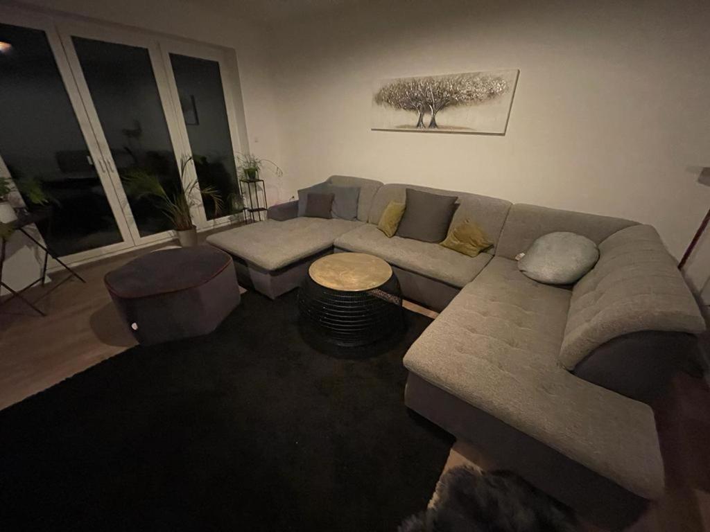 a living room with a couch and a table at Lux Apartmant 2 Westerstede in Westerstede