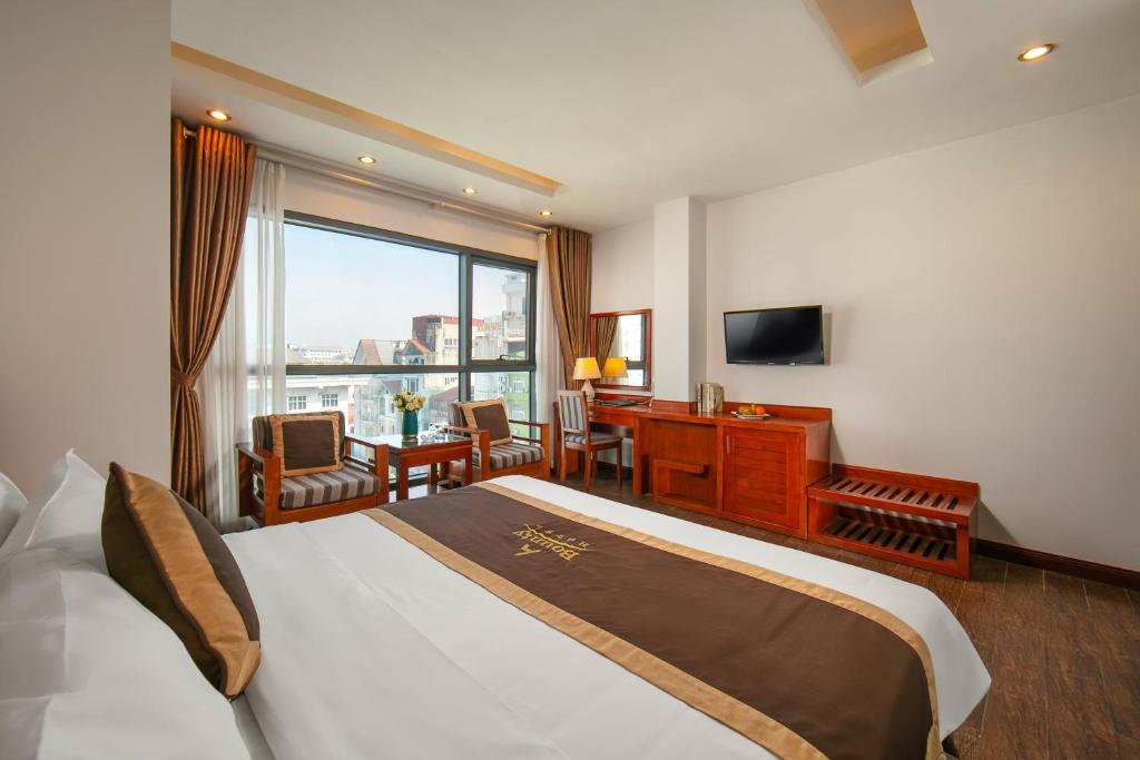 Postel nebo postele na pokoji v ubytování Bounty Hotel