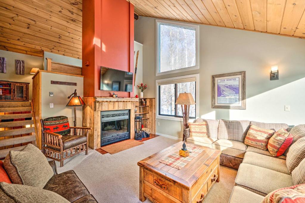 a living room with a couch and a fireplace at Lincoln Condo with Balcony Less Than 2 Mi to Loon Mtn! in Lincoln