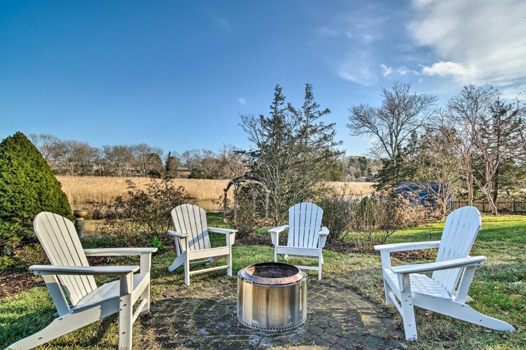 a group of three chairs sitting around a fire pit at Riverfront Kingston Home with Deck and Fire Pit! in Kingston