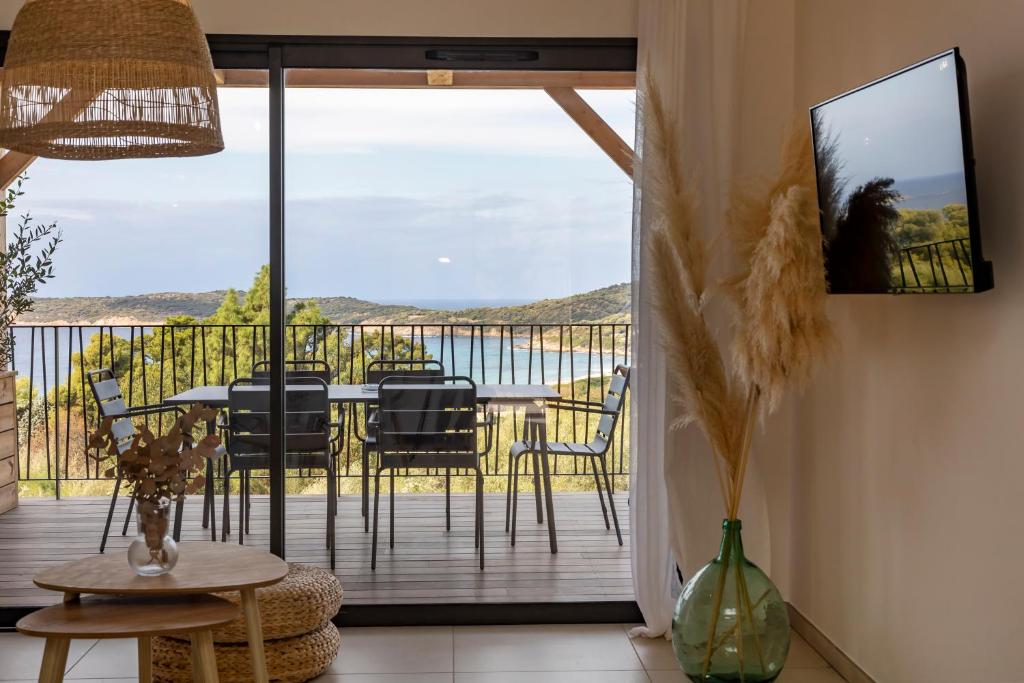 une chambre avec un balcon avec une table et des chaises dans l'établissement Casa Marina Cargèse, à Cargèse