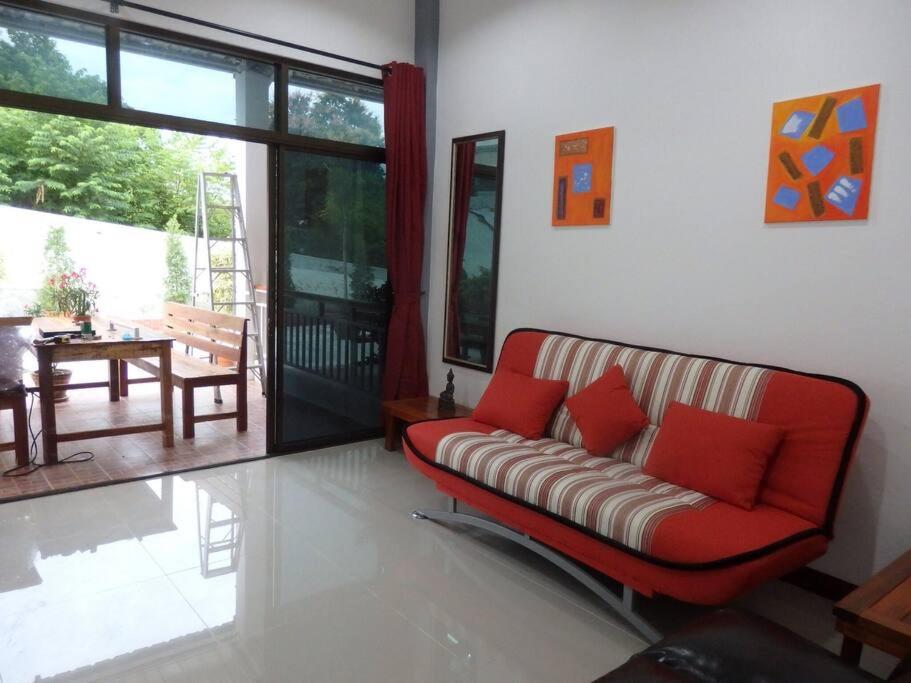 a living room with a couch with red pillows at Judith's 2 bedroom family home, sleeps 6 in Ko Samed