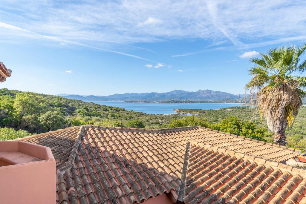 a roof of a house with a view of the ocean at ISS Travel, Panoramic Coda Cavallo Cottages - 10 km from San Teodoro in San Teodoro