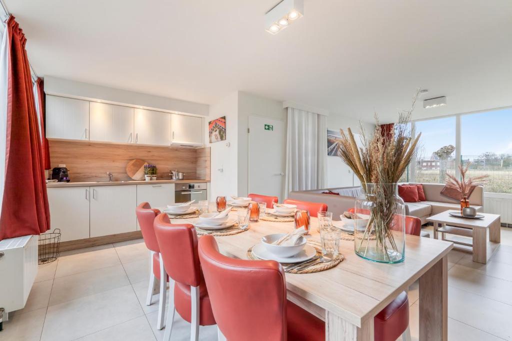 a kitchen and dining room with a table and chairs at Dunewave - spacious house for 8 persons in Westende in Middelkerke