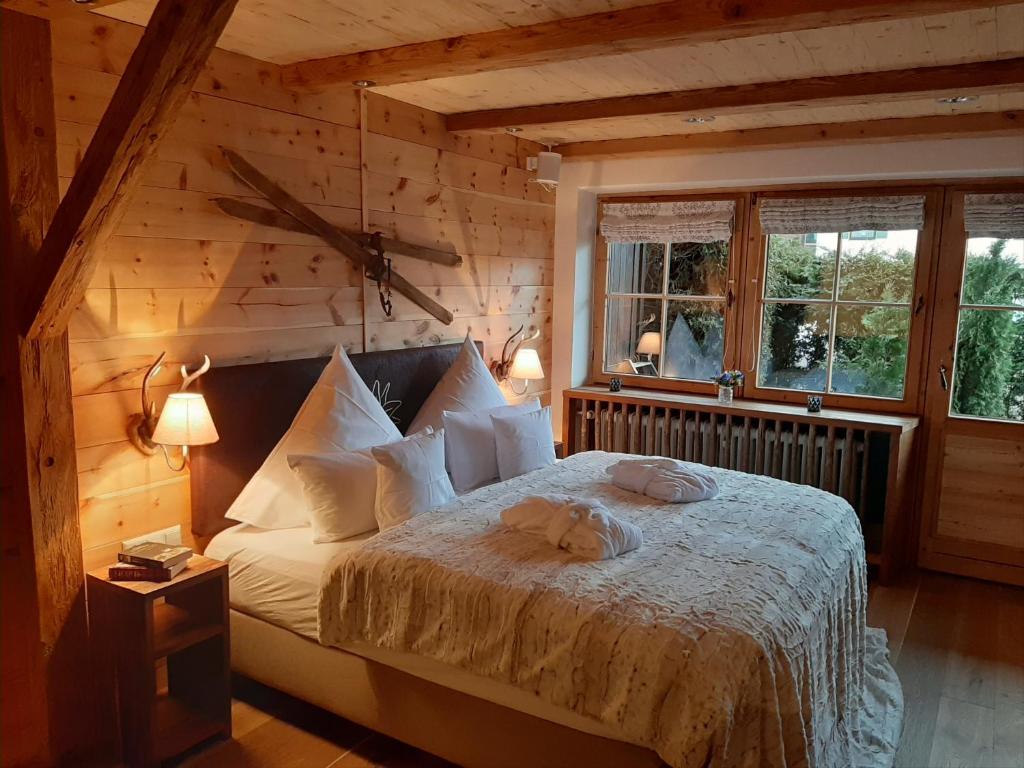 a bedroom with a bed in a log cabin at Superior Suite Bergparadies Sauna - barrierfree in Inzell