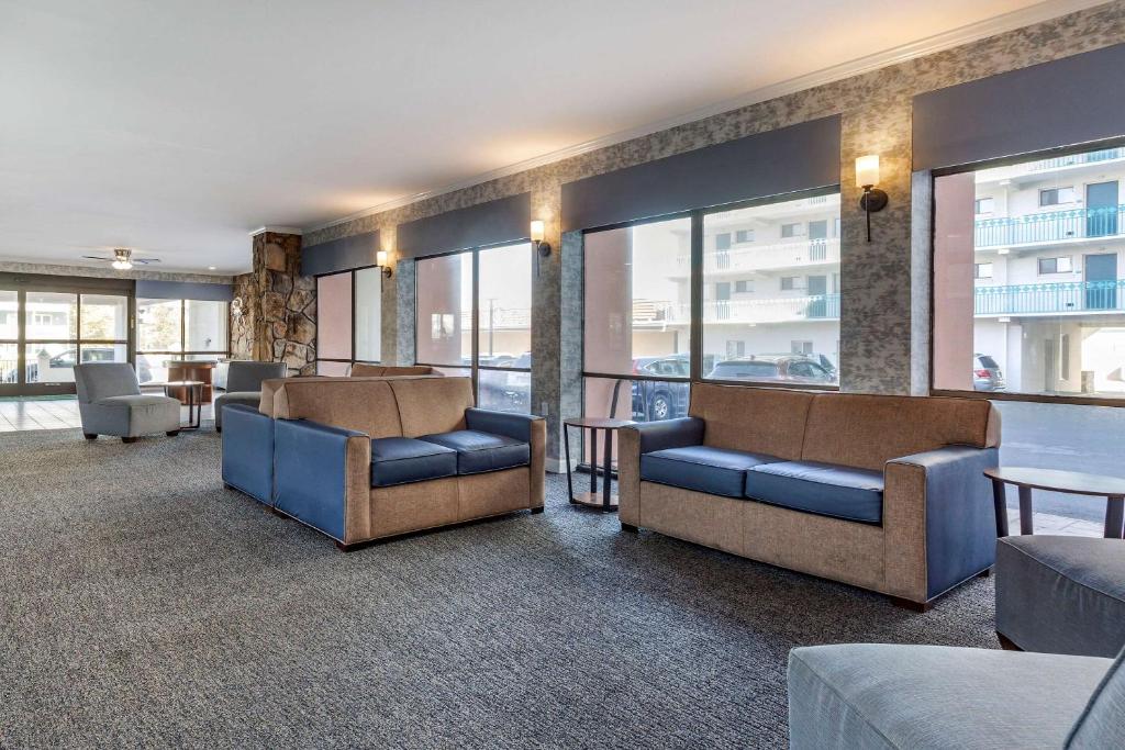 a waiting room with couches and tables and windows at Quality Inn Boardwalk in Ocean City