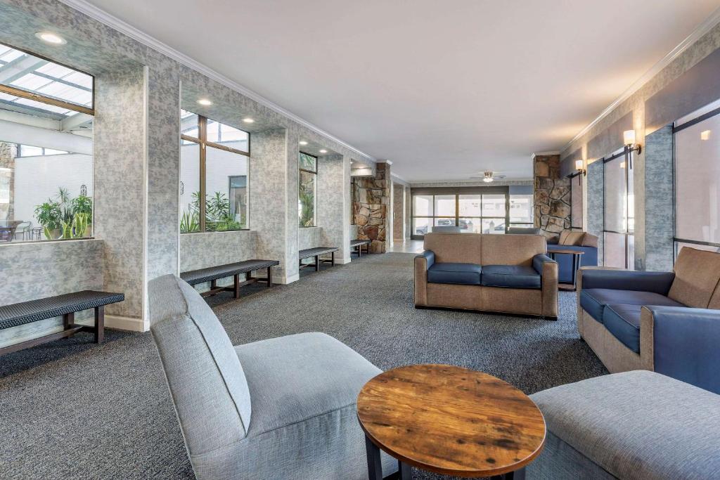 a waiting room with couches and tables and windows at Quality Inn Boardwalk in Ocean City