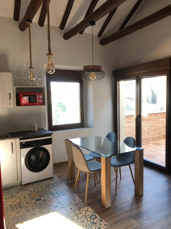 a kitchen with a table and chairs in a room at Mirador de San Juan in Toledo