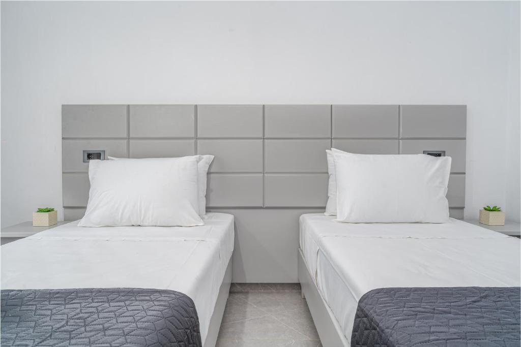 two beds sitting next to each other in a room at Panorama in Laganas