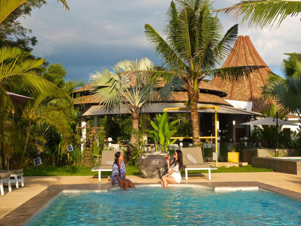 um grupo de pessoas sentadas na piscina de um resort em Barong Resort em Ban Phe