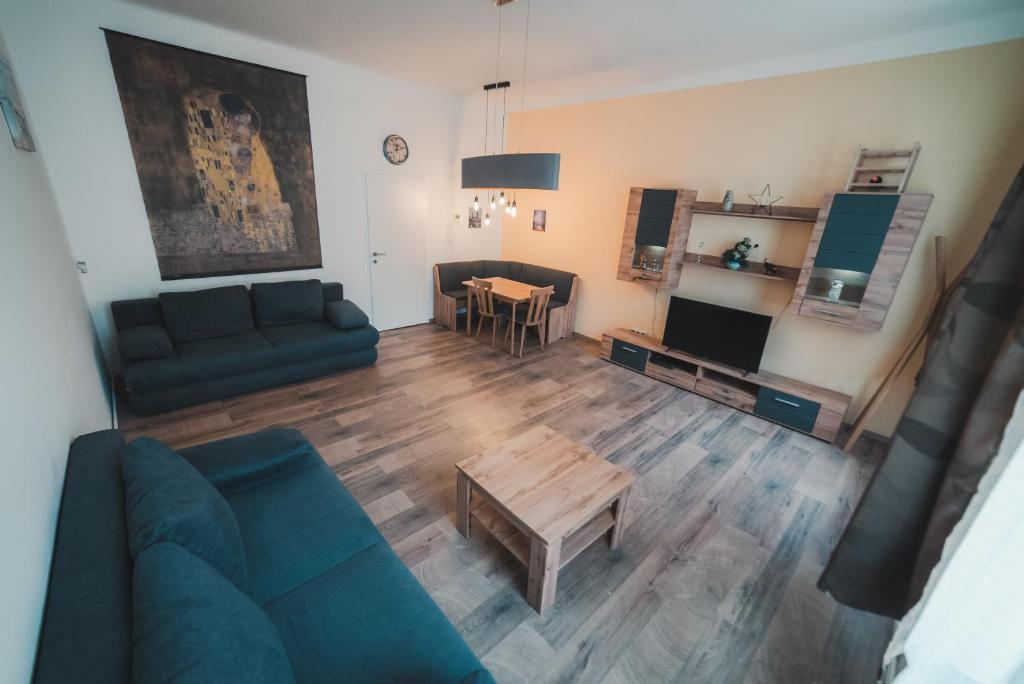 a living room with a couch and a table at Renovated Apartment close to first district in Vienna