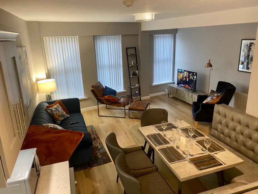 a living room with a couch and a table at Dunlap Apartments in Strabane