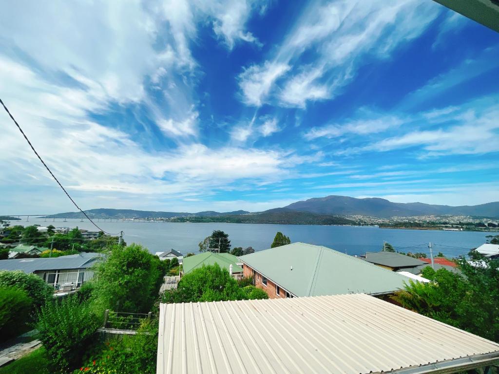a view of a large body of water with mountains at Spectacular Hobart River View Home in Lindisfarne