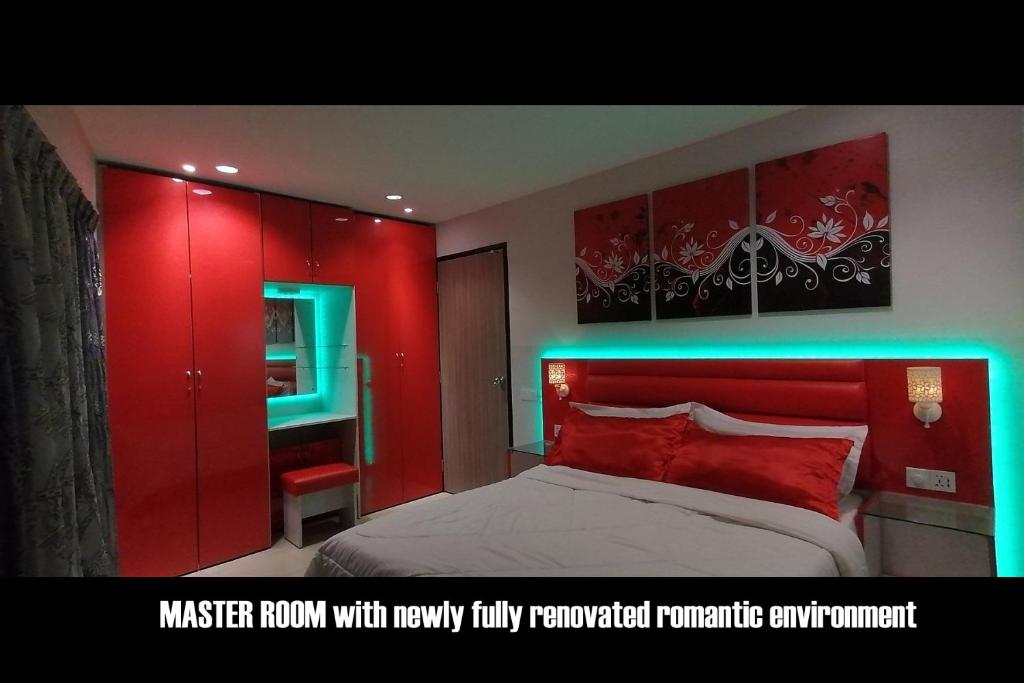 Una cama o camas en una habitación de Penang karaoke Ruby Townhouse 1st floor