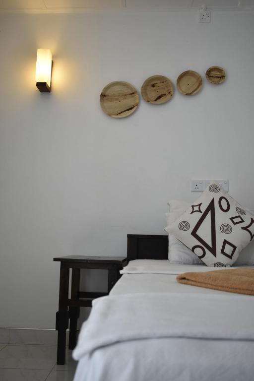 Postel nebo postele na pokoji v ubytování Sigiri Rock Side Home Stay